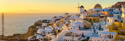 White churches and blue domes by the ocean of Oia Santorini Greece, a traditional Greek village in Santorini in the evening light © Fokke Baarssen