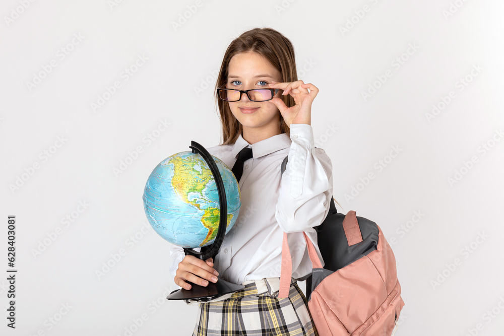Back to school. Charming teenage girl backpacks and school globe in hands is posing on white background. Back to school. Charming teenage girl backpacks and school globe in hands is posing on white background.