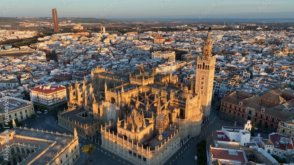 Fototapeta premium Gorgeous sunrise in Seville, Spain. Aerial shot of Seville city center with gothic cathedral and famous Giralda bell tower