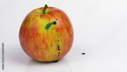 Poison Injected into Apple from Syringe by Person in Blue Gloves