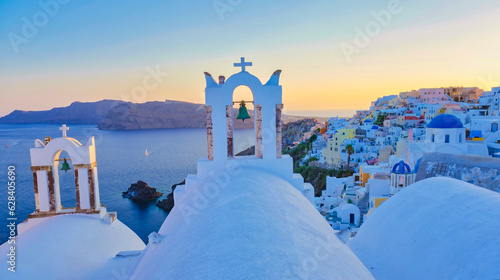 White churches an blue domes by the ocean of Oia Santorini Greece, a traditional Greek village in Santorini.