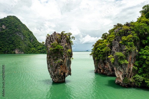 Khao Tapu, James Bond Island, aerial shot from a drone, blue sea, emerald green, is a popular tourist attraction in Southern Thailand. © Theerawat