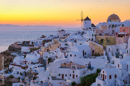 White churches and blue domes by the ocean of Oia Santorini Greece, a traditional Greek village in Santorini in the evening light