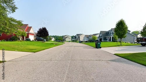 Slow pull back along the suburban street in summer. photo