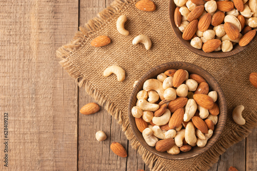 Papier peint Large assortment of nuts in different bowls on stone table.