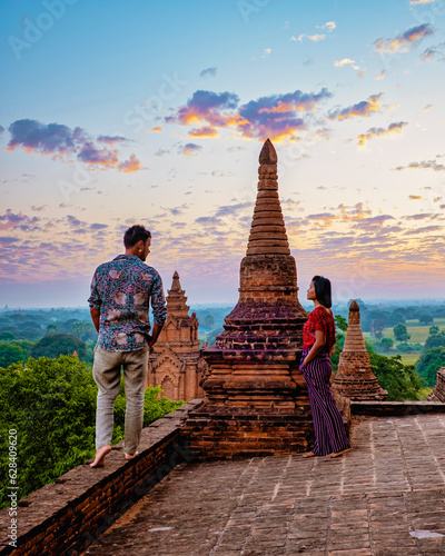 Bagan Myanmar, Sunrise above temples and pagodas of Bagan Myanmar, Sunrise Pagan Myanmar temple and pagoda. Men and woman at an old pagoda during a vacation in Myanmar, couple visit a temple in Bagan