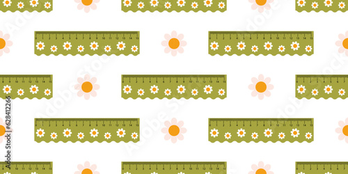 Vector seamless pattern with cute green measuring rulers. School rulers and chamomile flowers on white background in flat design.  Print with measuring tools.