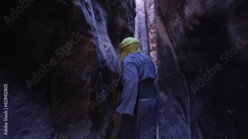 Tuareg in a narrow sandstone path Tassili N'Ajjer Park Tadrart Rouge Algeria photo