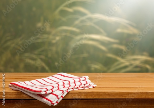 Blank wooden table over wheat field background.