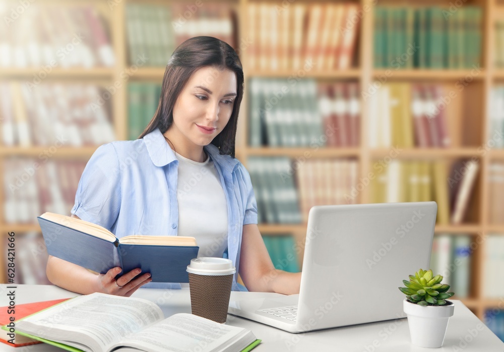 Pretty student girl preparing for exams in the library. Pretty student girl preparing for exams in the library.