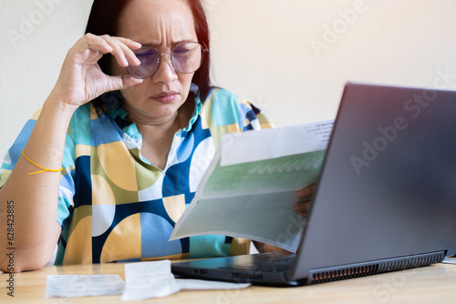 Confused frustrated Asian woman holding mail letter reading shocking unexpected news nonsense