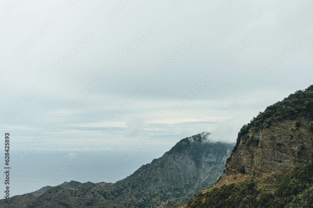 View of rocky steep volcanic mountains valley and sea on atlantic island