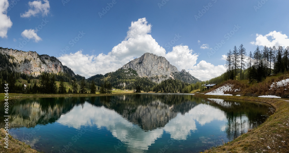 incredible view to a nature landscape with reflections in a mountain lake named wurzeralm in austria panorama