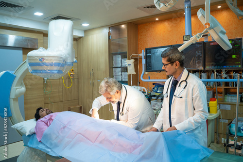 Doctor with patient in operation theater at hospital.