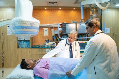 Doctor with patient in operation theater at hospital.