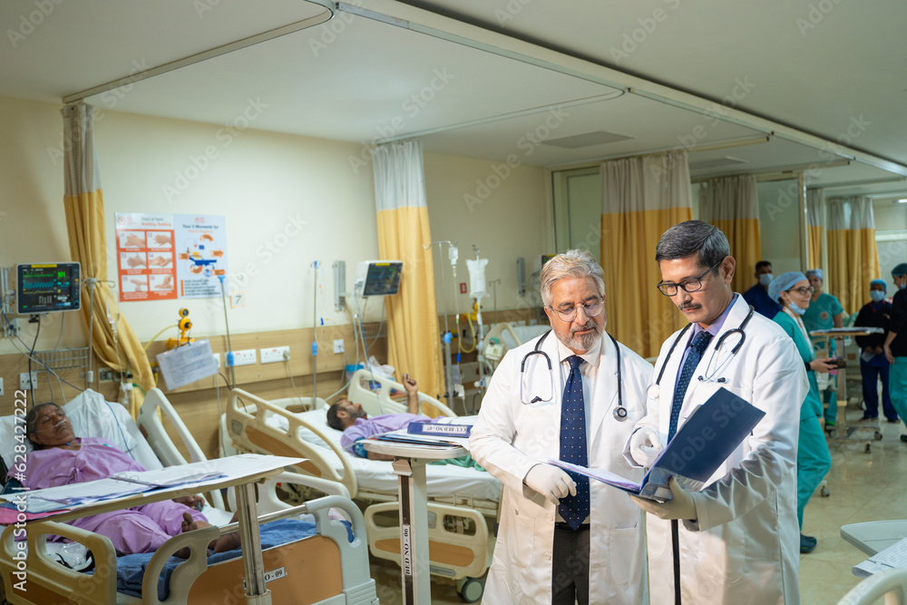 Indian doctor looking medical report at hospital. Indian doctor looking medical report at hospital.