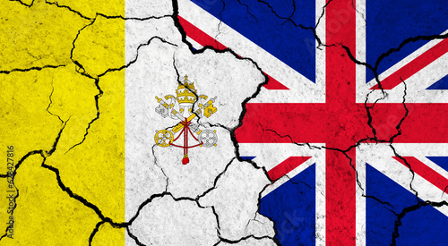 Flags of Vatican City and United Kingdom on cracked surface - politics, relationship concept