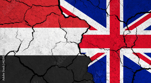Flags of Yemen and United Kingdom on cracked surface - politics, relationship concept