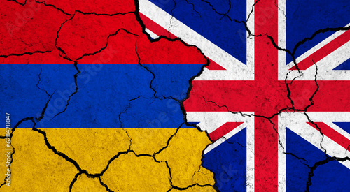 Flags of Armenia and United Kingdom on cracked surface - politics, relationship concept