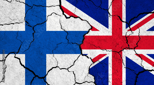 Flags of Finland and United Kingdom on cracked surface - politics, relationship concept