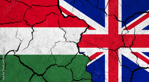 Flags of Hungary and United Kingdom on cracked surface - politics, relationship concept