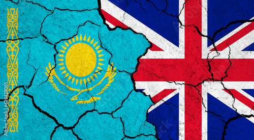 Flags of Kazakhstan and United Kingdom on cracked surface - politics, relationship concept