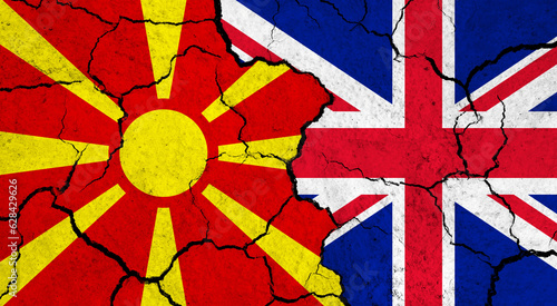 Flags of Macedonia and United Kingdom on cracked surface - politics, relationship concept