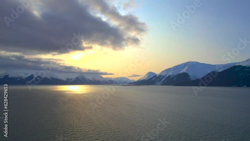 Scenic view of the mountains at sunrise along the scenic byway from Anchorage Alaska to Seward Alaska. 4k drone. photo