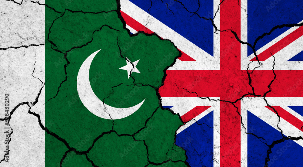 Fototapeta premium Flags of Pakistan and United Kingdom on cracked surface - politics, relationship concept
