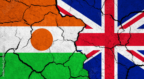 Flags of Niger and United Kingdom on cracked surface - politics, relationship concept