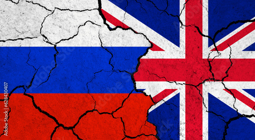 Flags of Russia and United Kingdom on cracked surface - politics, relationship concept