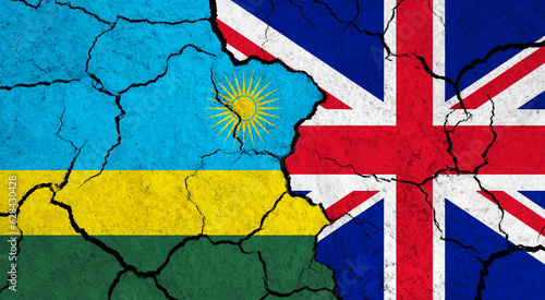 Flags of Rwanda and United Kingdom on cracked surface - politics, relationship concept