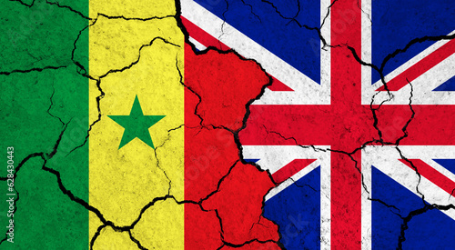 Flags of Senegal and United Kingdom on cracked surface - politics, relationship concept