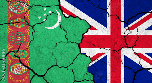 Flags of Turkmenistan and United Kingdom on cracked surface - politics, relationship concept