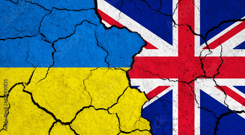 Flags of Ukraine and United Kingdom on cracked surface - politics, relationship concept