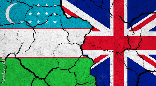 Flags of Uzbekistan and United Kingdom on cracked surface - politics, relationship concept