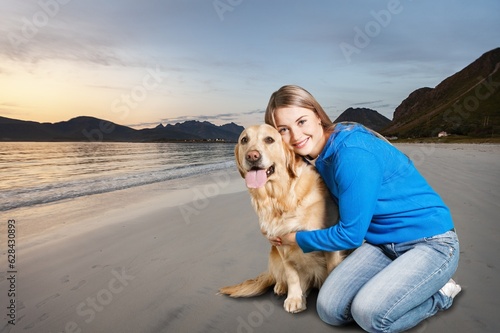 Happy young woman at beach with cute dog