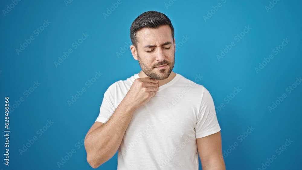 Young hispanic man coughing over isolated blue background Young hispanic man coughing over isolated blue background