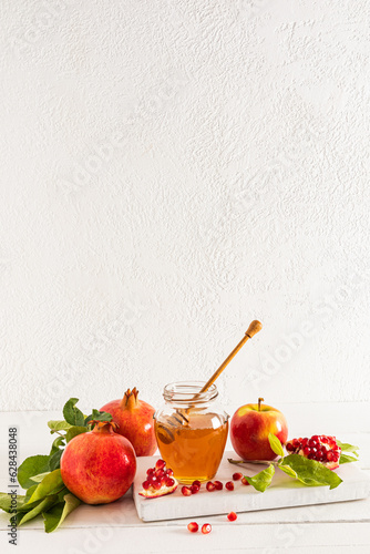 Canvas Print Beautiful still life with ripe pomegranates and apples, a bowl of honey