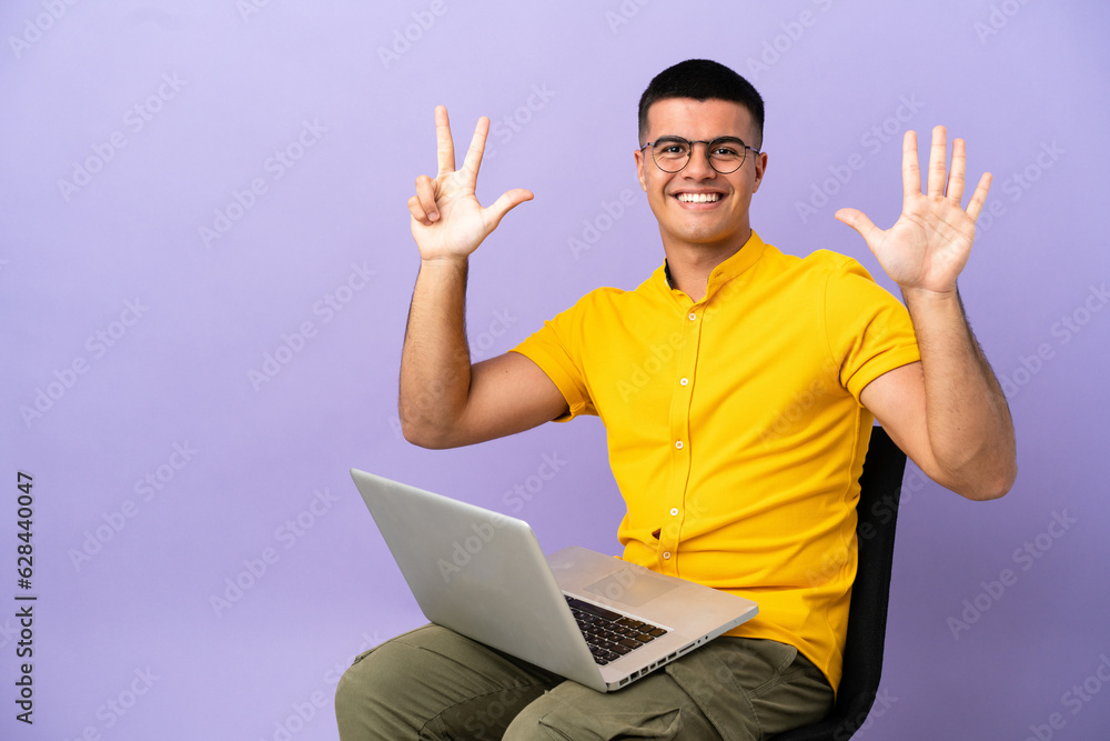 Young man sitting on a chair with laptop counting eight with fingers Young man sitting on a chair with laptop counting eight with fingers