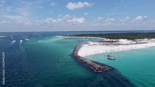 Green crystal clear waters, Blue skies, and white sands, at Shell island on Florida’s Emerald Coast. Shell Island next to St. Andrews State Park. Aerial drone shot taken with DJI drone at Panama City. photo