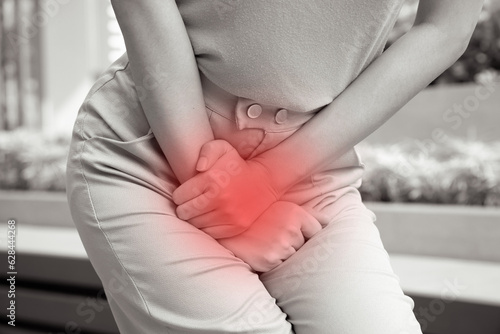 woman holding her pee, health care concept of urinary tract infection; urinary incontinence; overactive bladder symptoms