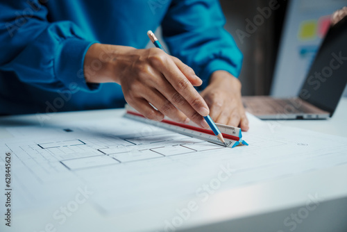 Female Industrial Engineers Look at Project Blueprints, measurements and drawing process of technical details on paper, International Labor Day Is 15 september a engineers day?