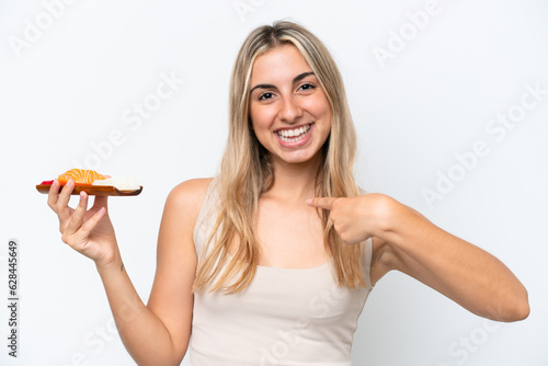 Young caucasian woman holding sashimi isolated on white background with surprise facial expression