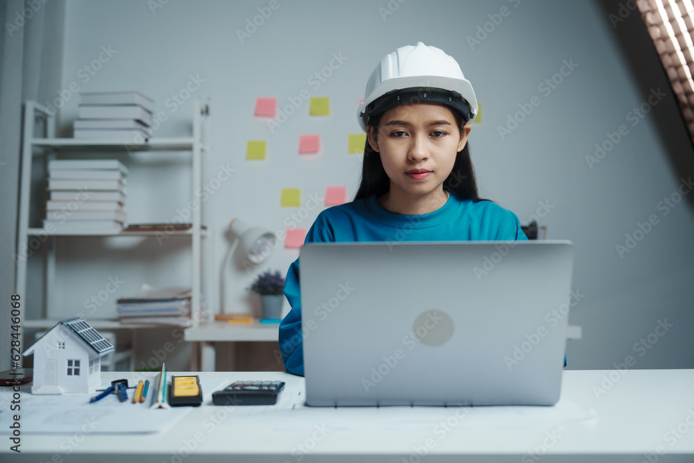 Female Industrial Engineers Look at Project Blueprints, measurements and drawing process of technical details on paper, International Labor Day Is 15 september a engineers day? Female Industrial Engineers Look at Project Blueprints, measurements and drawing process of technical details on paper, International Labor Day Is 15 september a engineers day?