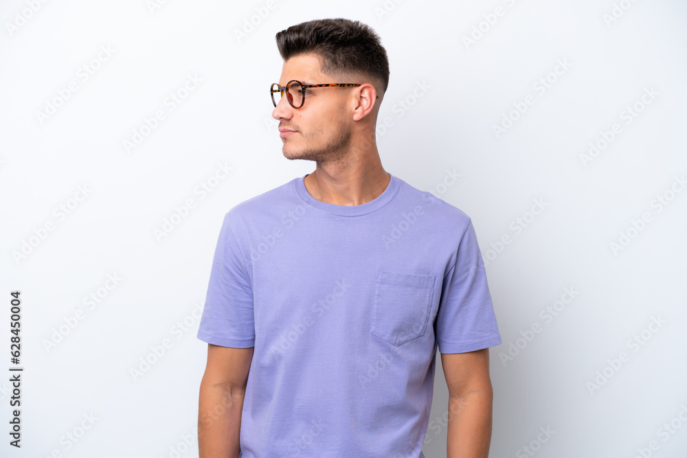 Young caucasian man isolated on white background looking to the side Young caucasian man isolated on white background looking to the side