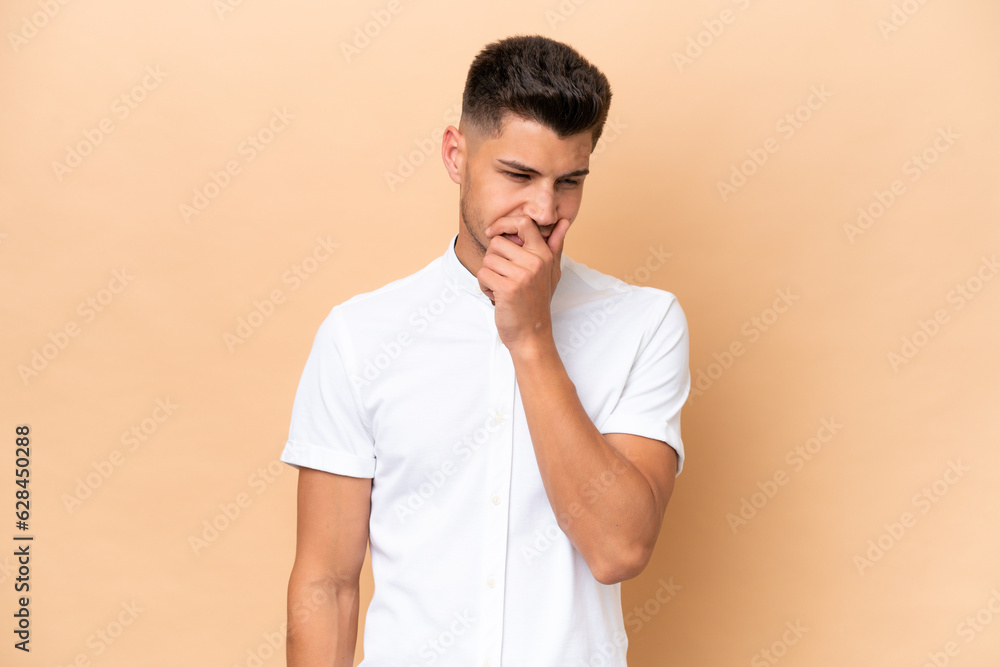 Young caucasian man isolated on beige background having doubts Young caucasian man isolated on beige background having doubts