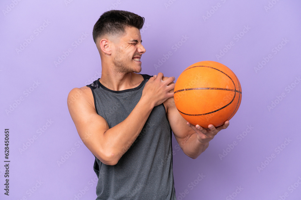 young caucasian woman  basketball player man isolated on purple background suffering from pain in shoulder for having made an effort