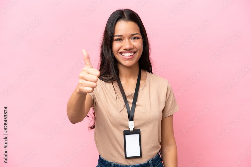 Young Colombian woman with a motorcycle helmet isolated on white background with thumbs up because something good has happened Young Colombian woman with a motorcycle helmet isolated on white background with thumbs up because something good has happened