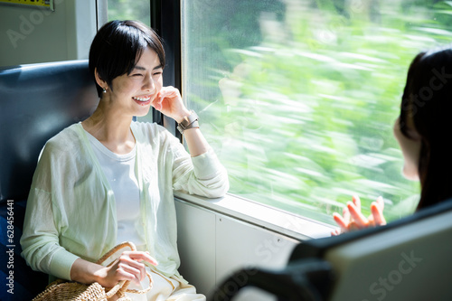 Two young, beautiful Asian women happily strolling around their destination. Tourism and lifestyles